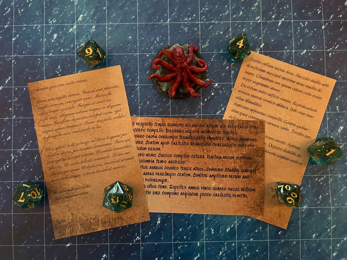 Random tables printed on index cards on a TTRPG mat with dice and minis